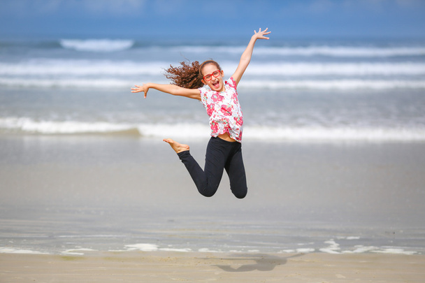 Girl jumping on the beach - Photo, Image