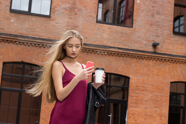 Young pretty blond girl with phone - Фото, зображення