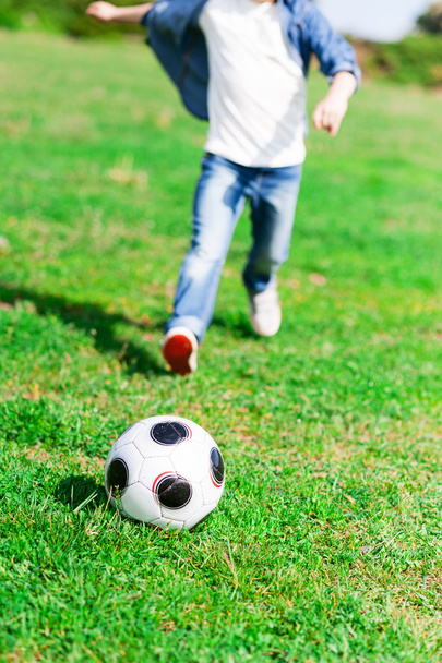 Cheerful male child is playing football - Foto, Imagem