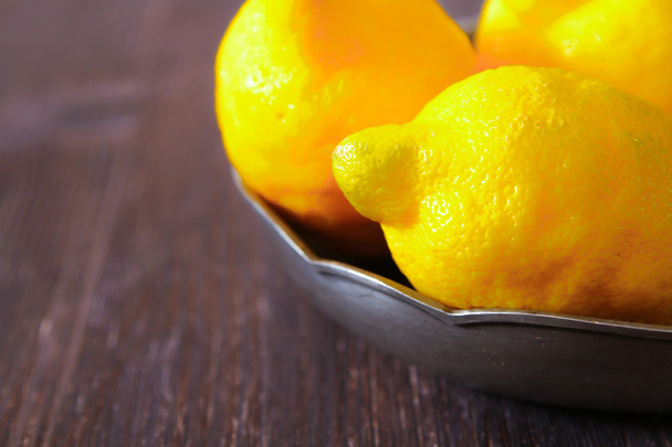 Fresh lemons on a wooden table. - Foto, imagen