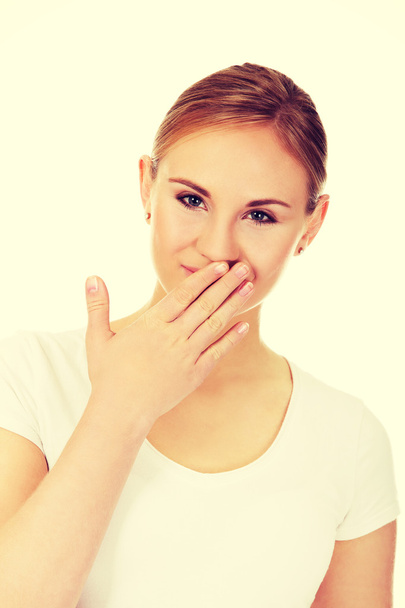 Giggles young woman covering her mouth with hand - Foto, Imagen