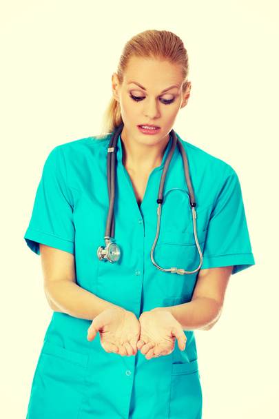 Female doctor or nurse holding something on open palms - Foto, Imagem