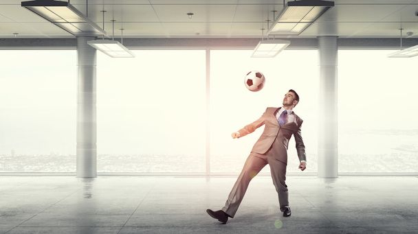 Playing football in office - Фото, изображение