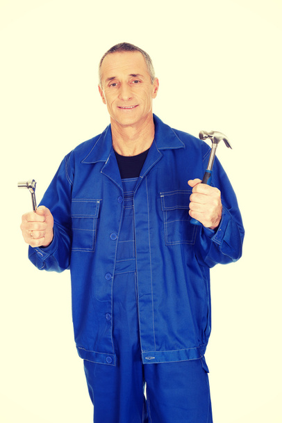 Worker showing his wrench and hammer - Photo, Image