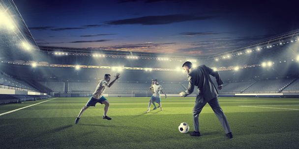 Businessman and player fighting for ball - Foto, Imagen