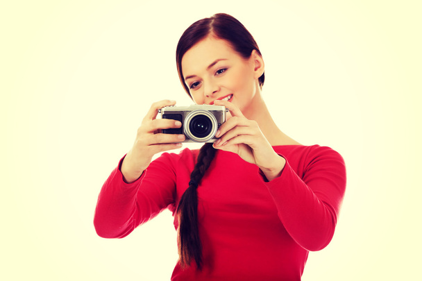 Pretty woman taking a photo using classic slr camera - Valokuva, kuva