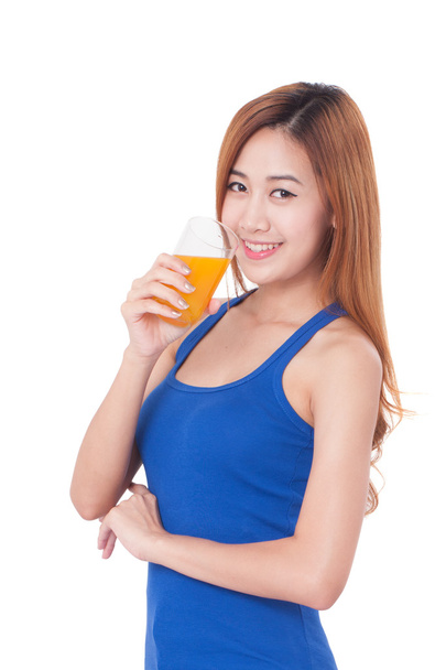 Portrait of young woman drinking orange juice. - Фото, изображение