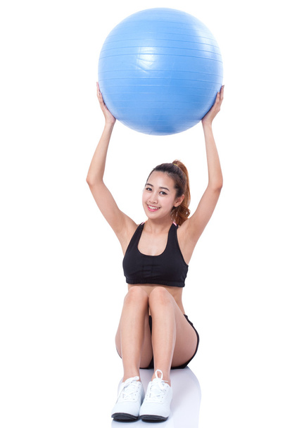 Young woman doing exercises with fitness ball. - Foto, Imagem