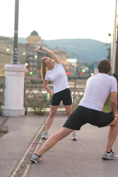 couple warming up before jogging - Фото, зображення