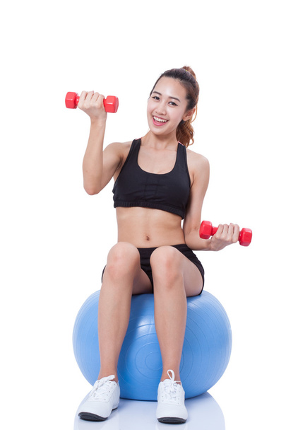 Fitness woman sport training with exercise ball and lifting weights - Fotó, kép