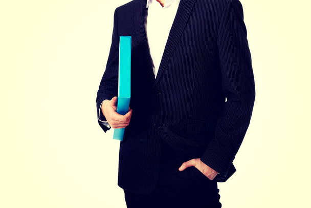Handsome businessman holding a binder. - Zdjęcie, obraz