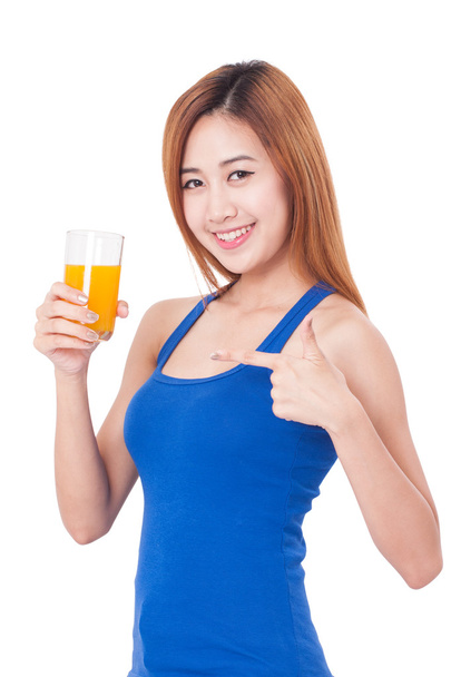 Portrait of young woman drinking orange juice. - Фото, изображение