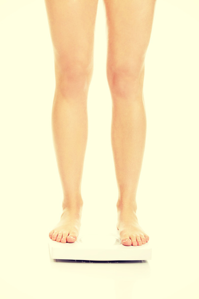 Slim womans legs on scale - Fotó, kép