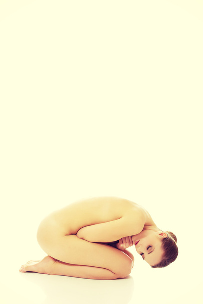 Beautiful spa woman curled up on the floor. - Φωτογραφία, εικόνα