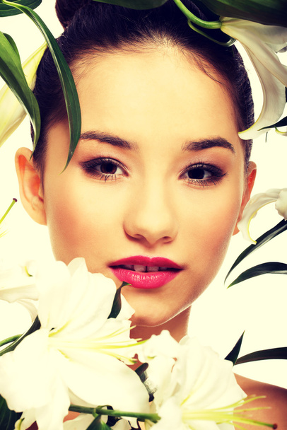 Beauty face of a woman with flowers. - Fotografie, Obrázek