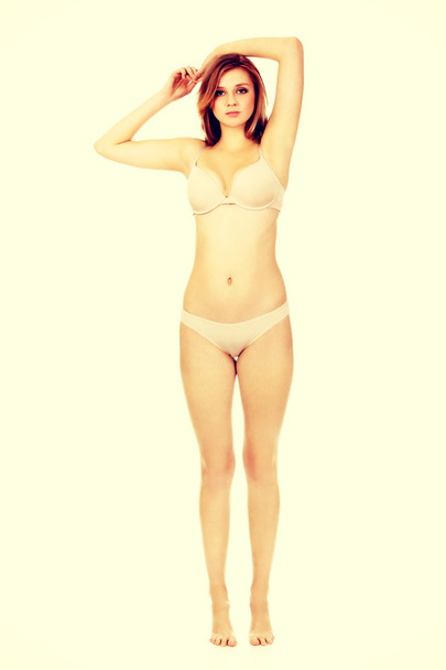 Teenage woman in beig underwear - Foto, afbeelding