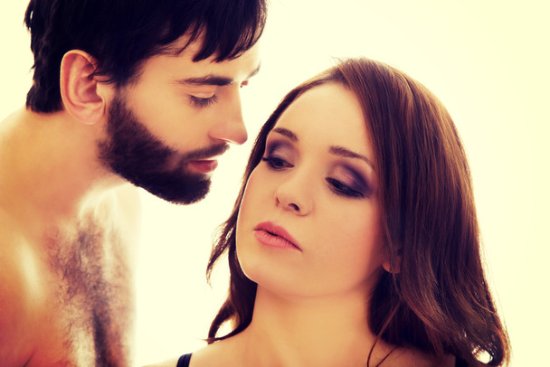 Shirtless man whispering to womans ear. - Фото, зображення