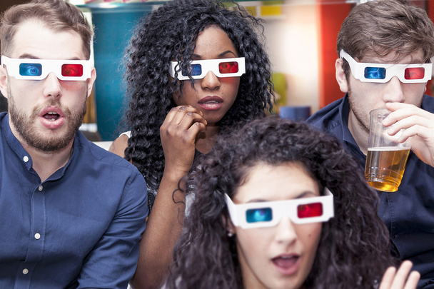 portrait of four young adults wearing 3d glasses at home - Foto, immagini