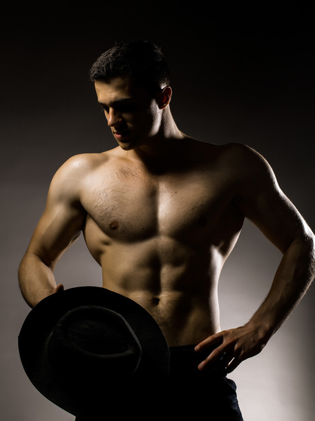 Sexy muscular man with hat - Foto, afbeelding