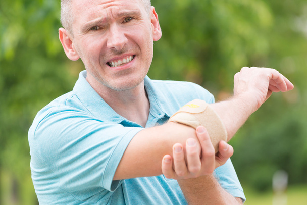 Man wearing elbow brace - Photo, Image