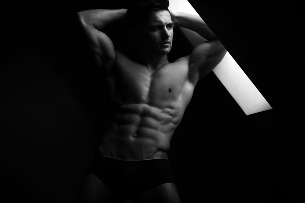 Muscular sexy man near window - Valokuva, kuva