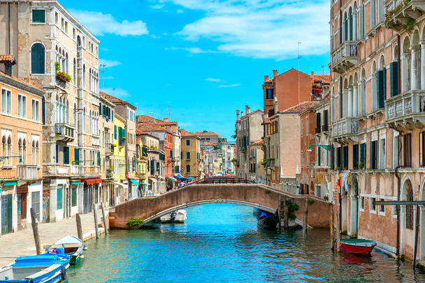 Bridge on canal with boats in Venice - Photo, Image