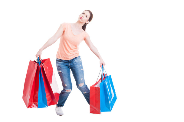 Young casual lady carrying heavy gift bags - Foto, Imagem