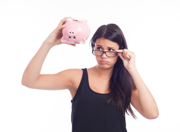 Young woman with a piggy bank - 写真・画像