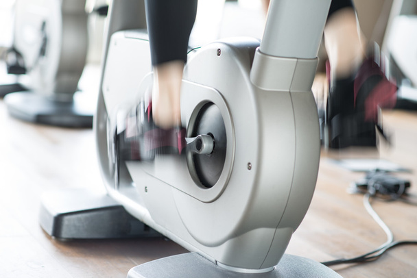 woman working out on stationary bike - Photo, Image