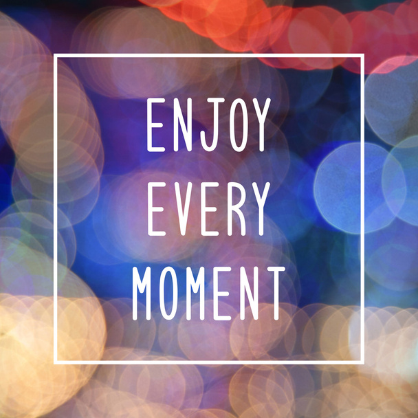 Enjoy every moment text on bokeh lights background - Foto, immagini