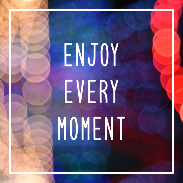 Enjoy every moment text on bokeh lights background - Foto, Imagen