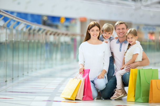 Smiling family in a store - Photo, Image