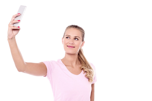 Pretty woman clicking a selfie - Фото, изображение