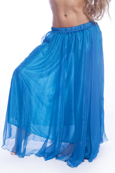 Young beautiful blonde girl in a long blue skirt - Photo, image