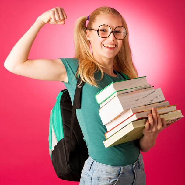 Curious, naughty, playful schoolgirl with stack of books and big - Φωτογραφία, εικόνα