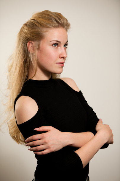 Beautiful young woman with gorgeous hairstyle posing  over white - Фото, изображение