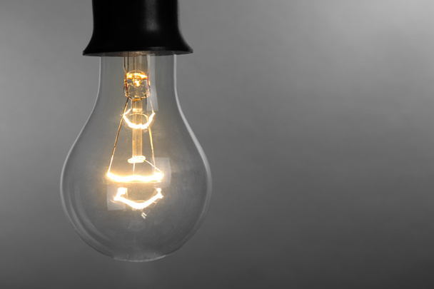Light bulb on grey  - Foto, afbeelding