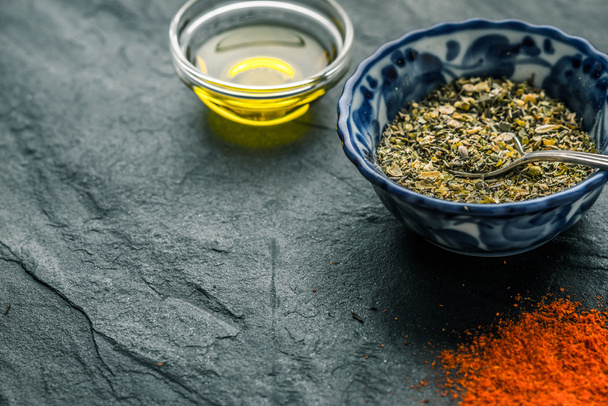 Mixture of spices, chilli, olive oil black shale from the right - 写真・画像