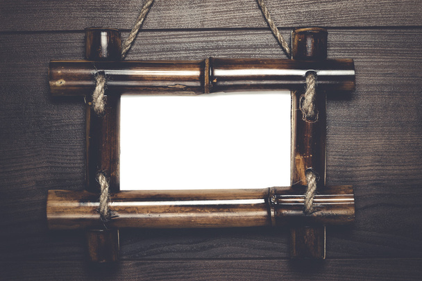 empty frame with copy space hanging on wooden wall - 写真・画像