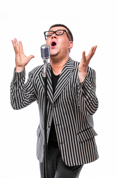 Showman concept. Singer listening music and sing in microphone  - Photo, Image
