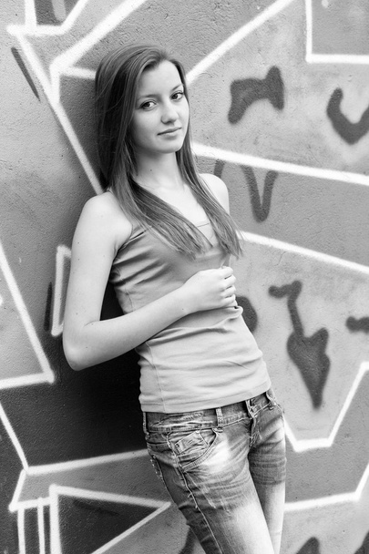 Style teen girl near graffiti background. - Photo, Image