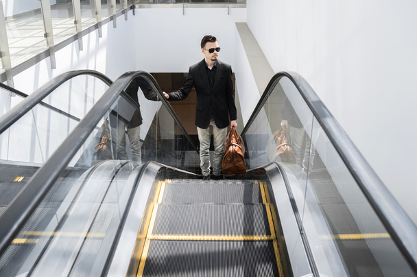 Portrait of stylish man going up on escalator - Fotoğraf, Görsel
