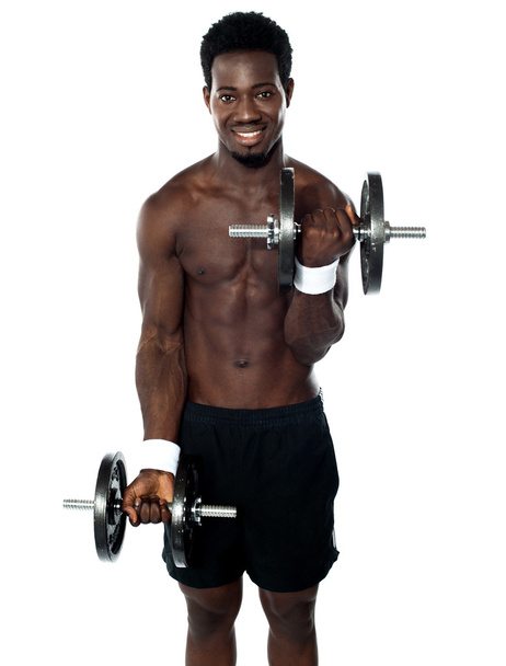 Muscular man doing exercise - Foto, Bild