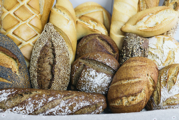 Many mixed breads and rolls. - Photo, Image