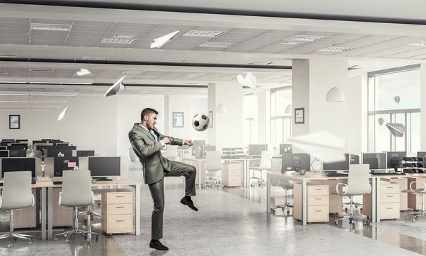 Playing football in office - 写真・画像