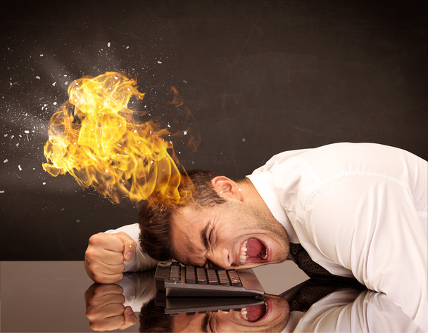 Stressed business man's head is burning - Foto, afbeelding