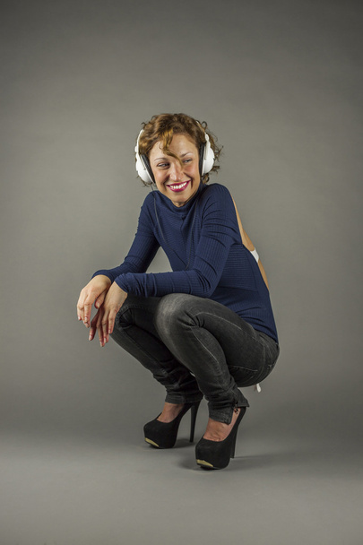 Portrait of curly hair young woman with headphones - Photo, Image
