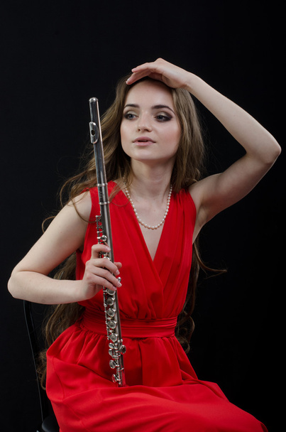 Menina com uma flauta
 - Foto, Imagem