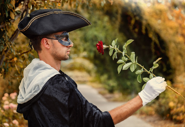 Romantic mystery man holding a rose - Photo, Image