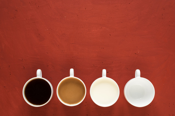 Four cups on red background - Φωτογραφία, εικόνα